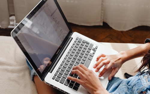 Woman typing on a computer searching for computer service